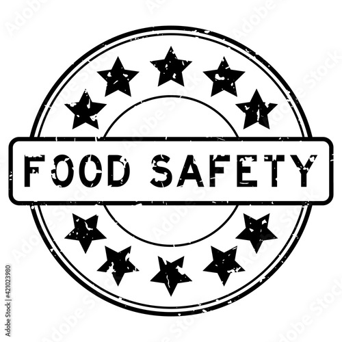 Grunge black food safety word with star icon round rubber seal stamp on white background