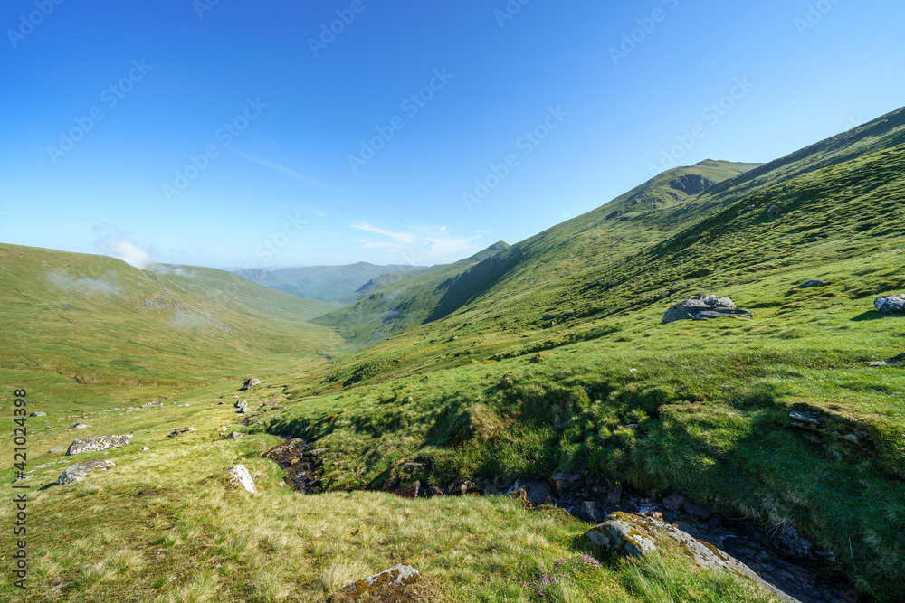 The valley, glen, of Allt a Chobhair below the summits of An Stuc and Ben Lawers with Carn Gorm off in the distance in the Scottish Highlands, UK landscapes.