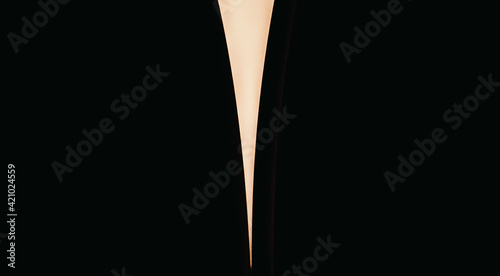 Triangular line on a black background. Separating a black background with a light detail