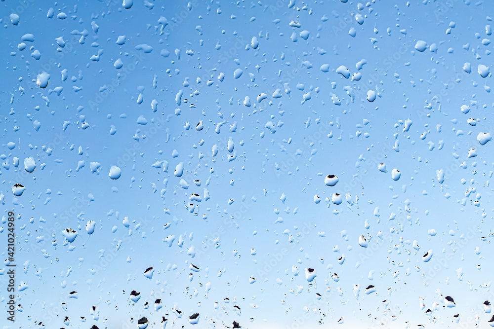 Raindrops on the window against the blue sky. Raindrops on the window against the blue sky.