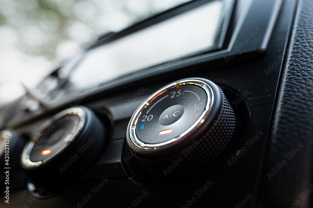 Car air condition temperature controlling switch with automatic adjustment function in luxury design. Close-up and selective focus, transportation part and technology object photo.