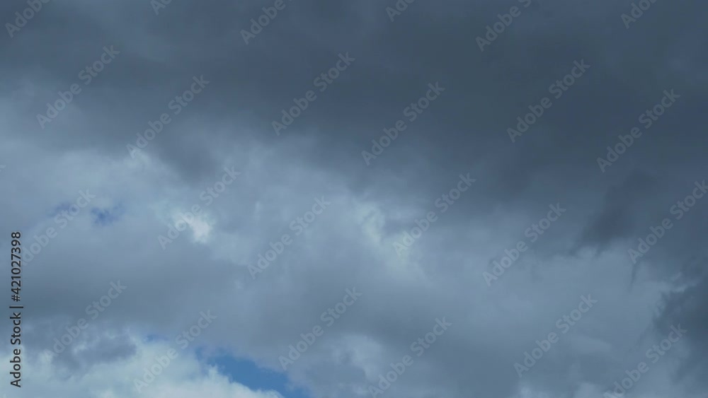 The Wind Blows away the Gray Black Storm Clouds in the Blue Sky of Time Lapse. Cloud Cover, Climate, Weather Forecast. Background of the Sky and Gray Transforming Clouds. The Wind Blows away the Gray Black Storm Clouds in the Blue Sky of Time Lapse. Cloud Cover, Climate, Weather Forecast. Background of the Sky and Gray Transforming Clouds.