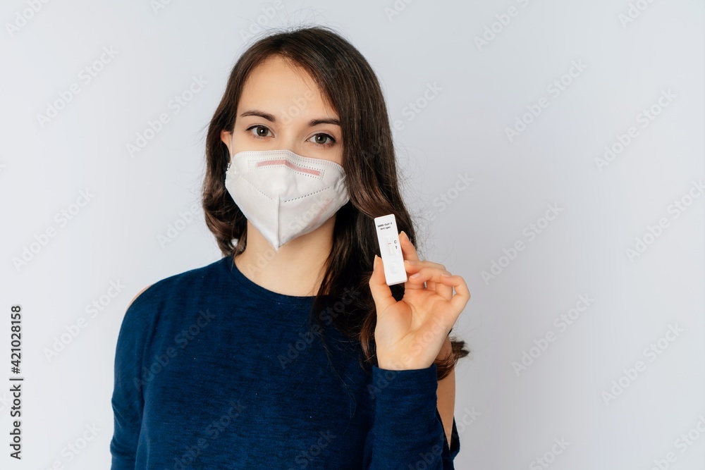 beautiful young woman wearing an anti viurs protection ffp2-mask to prevent from corona covid-19 and sars cov 2 infection white background copy space test kid beautiful young woman wearing an anti viurs protection ffp2-mask to prevent from corona covid-19 and sars cov 2 infection white background copy space test kid