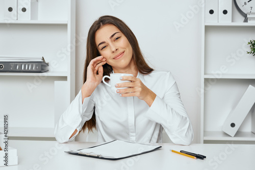 A woman is calmly working in the office with documents © SHOTPRIME STUDIO