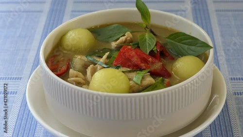 Green curry with chicken and mix vegetables in white bowl