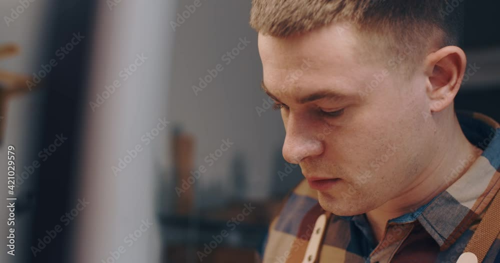 custom made wallpaper toronto digitalHandheld portrait male caucasian craftsman, worker, carpenter working with wood on work table in workshop in evening. Attractive young man wearing orange checkered shirt. Manufacturing hobby concept