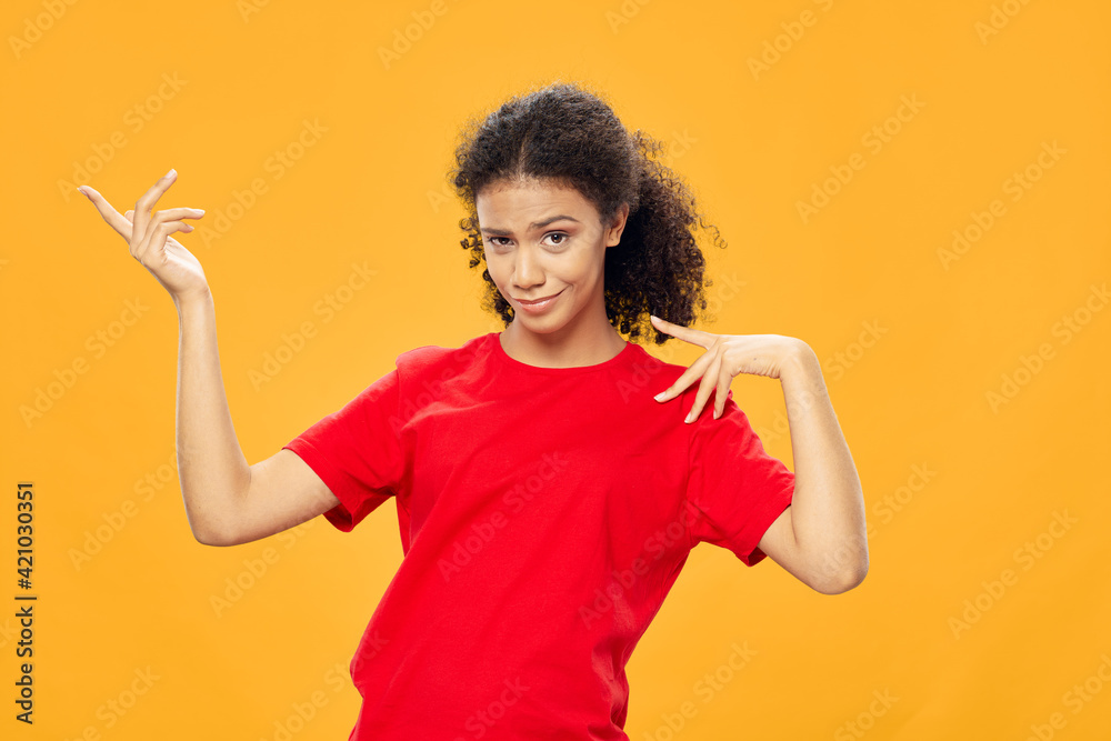 The girl in the red tank shows a finger to the side 