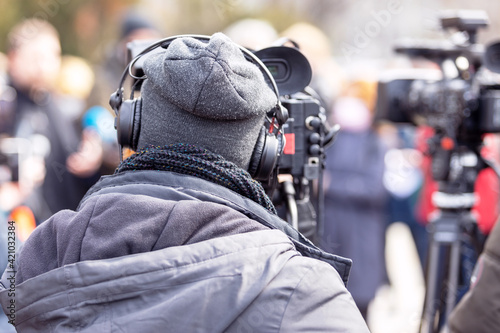 Filming an media event or news conference with a video camera. Public relations - PR concept.