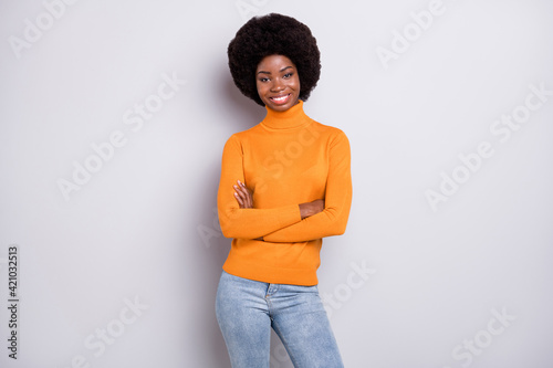 Photo of young attractive african girl happy positive smile confident folded hands isolated over grey color background