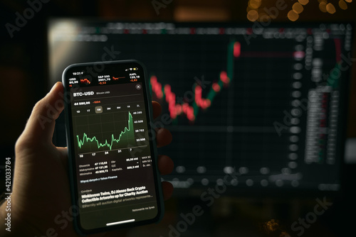 Stock market on the screen of the phone and in the background. Stock analysis and currency exchange.