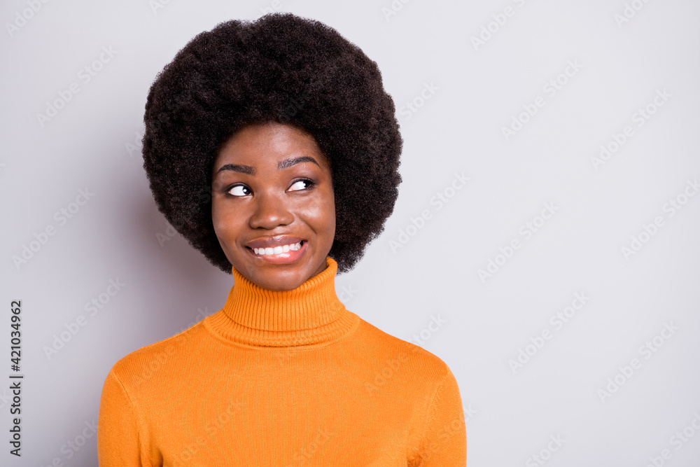 Portrait of pretty curly hairstyle lady biting lip look empty space thinking imagine isolated on grey color background Portrait of pretty curly hairstyle lady biting lip look empty space thinking imagine isolated on grey color background