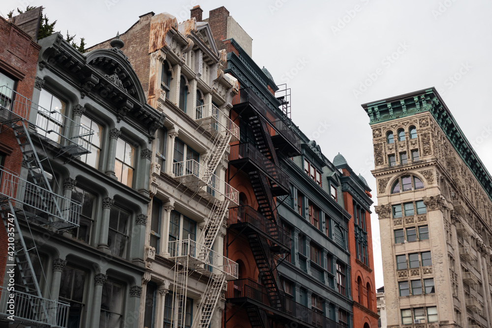 Row of Colorful Old Buildings in SoHo of New York City with Fire Escapes