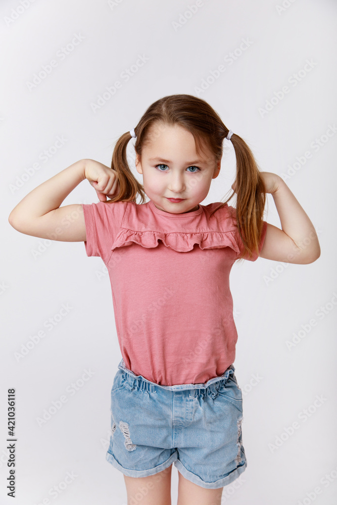 Little girl showing her strength and biceps Little girl showing her strength and biceps