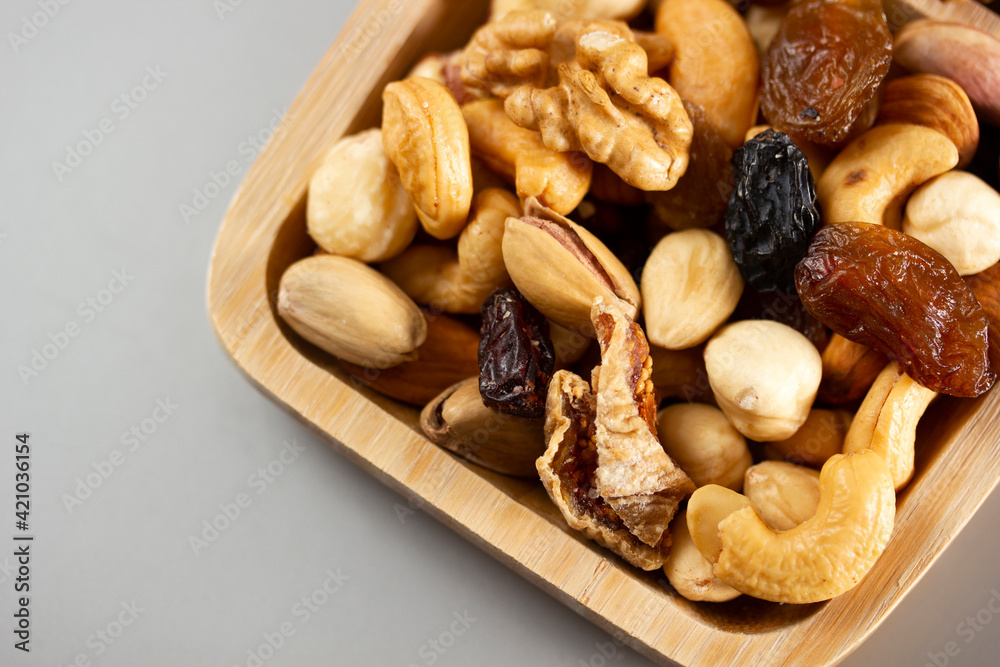 Mixed nuts in a bamboo plate. Healthy food concept.
