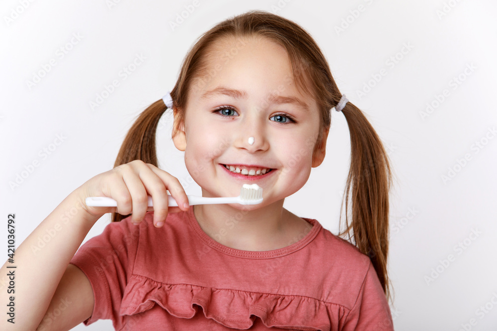 Smiling girl while brushing teeth Smiling girl while brushing teeth