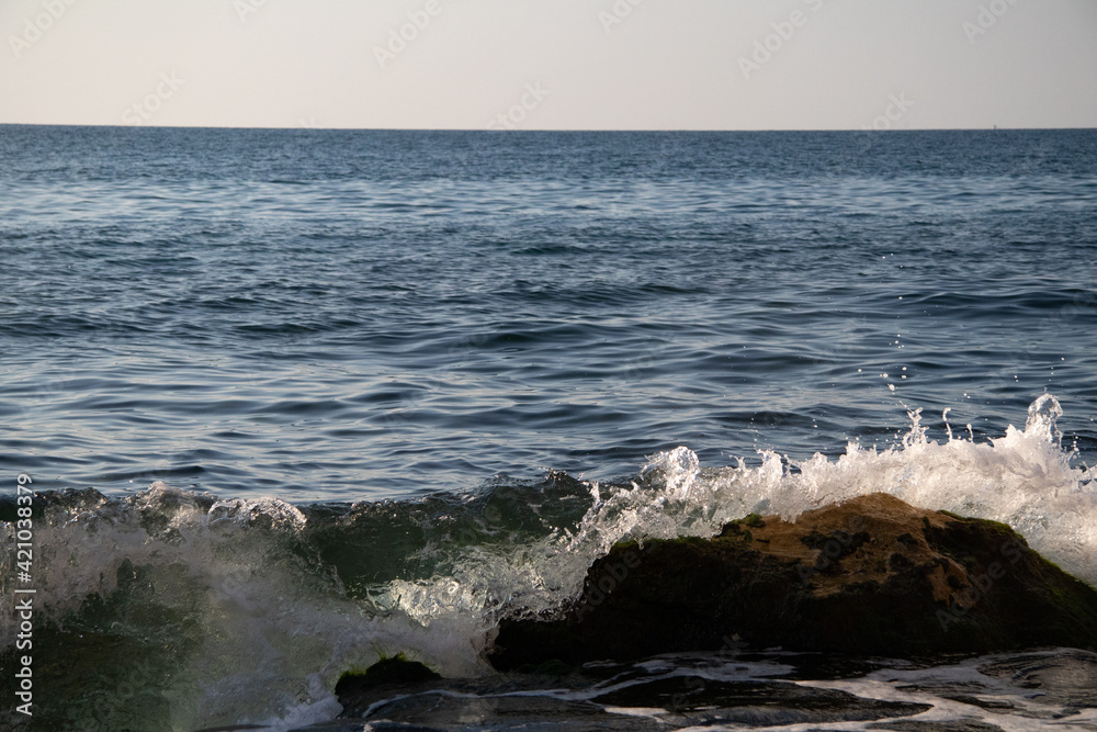 sea waves breaks on a rocky coast