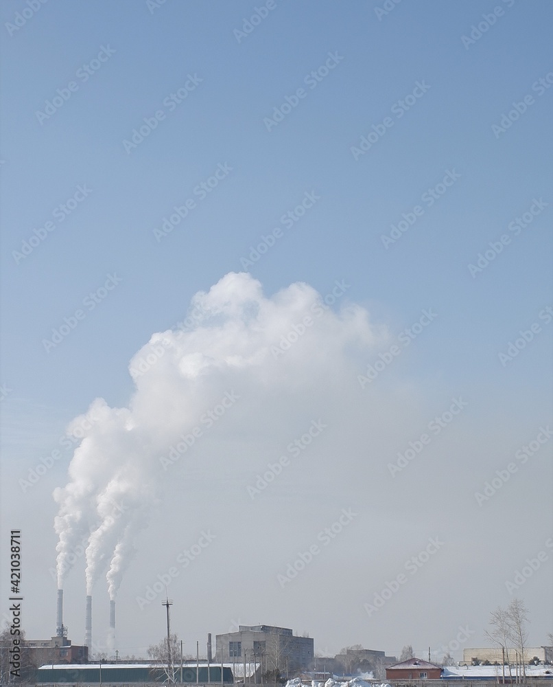 winter white smoke from chimneys on blue sky background winter white smoke from chimneys on blue sky background