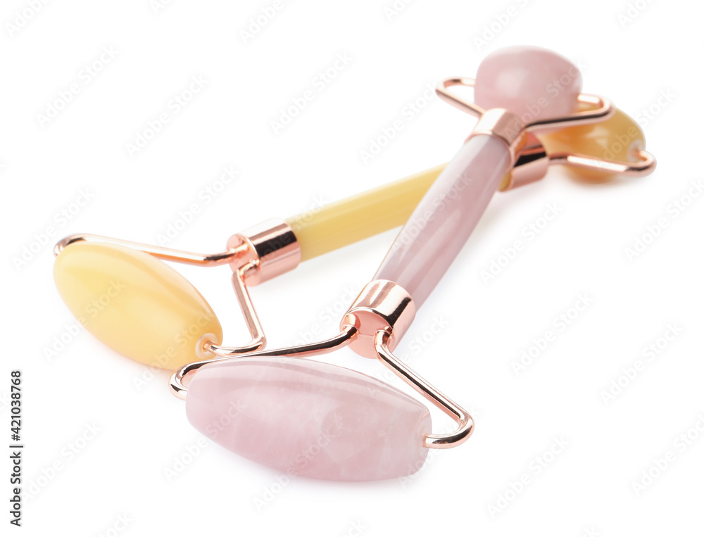 Different natural face rollers on white background