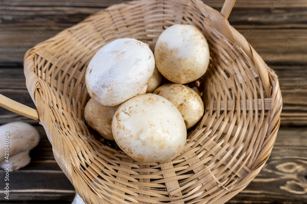 Still life, Food photo of mushrooms champignons. Mushrooms whole and chopped, basket with mushrooms Still life, Food photo of mushrooms champignons. Mushrooms whole and chopped, basket with mushrooms