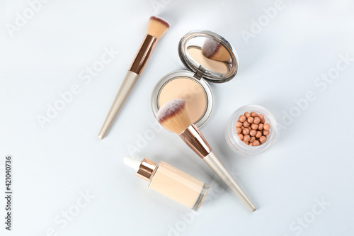 Flat lay composition with makeup brushes on light background
