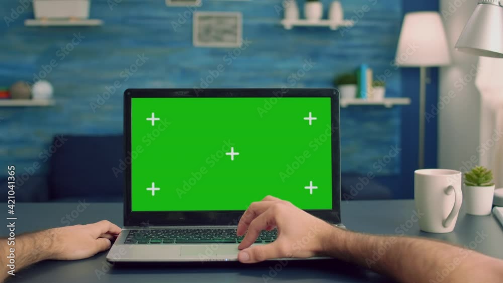 Point of view of man hands typing on laptop computer with mock up green screen chroma key display for e commerce courses. Freelancer using isolated device standing on desk table in home office studio Point of view of man hands typing on laptop computer with mock up green screen chroma key display for e commerce courses. Freelancer using isolated device standing on desk table in home office studio