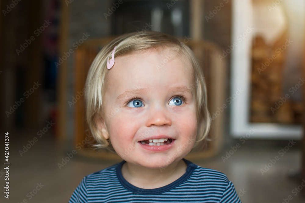Happy caucasian baby face, close up portrait. Small kid posing and smiling at home. Indoor portrait with copy space. Happy caucasian baby face, close up portrait. Small kid posing and smiling at home. Indoor portrait with copy space.