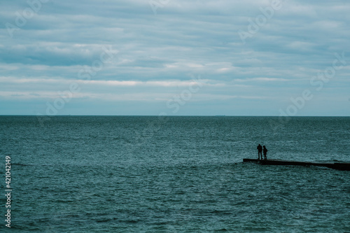 couple standing on the pier. Black Sea. minimalism
