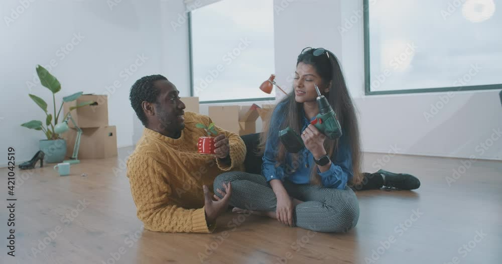 Funny multi-ethnic couple in their new apartment Funny multi-ethnic couple in their new apartment
