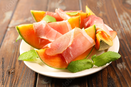 melon slices with prosciutto ham and basil