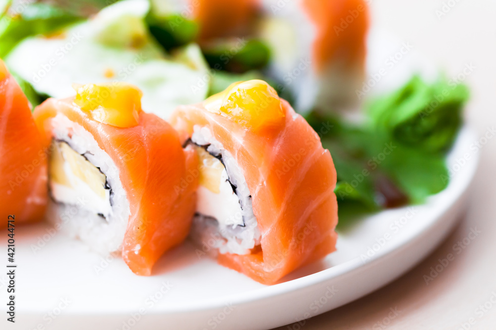 Traditional Japanese sushi rolls with salmon, closeup Traditional Japanese sushi rolls with salmon, closeup