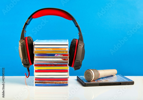 Audio microphone with CDs on a blue background.