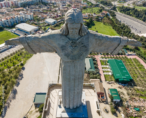 Aerial view of Christ the King (Cristo Rei) landmark statue from above, view of the garden surrounding the touristic site on hilltop, Almada, Portugal.