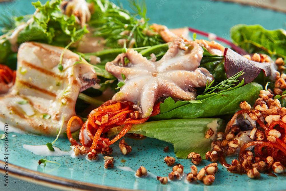 Seafood salad with crispy buckwheat and mixed greens. Frutti di Mare salad with mixed seafood - salmon, calamari, octopus. Gourmet restaurant salad plate. Seafood salad with crispy buckwheat and mixed greens. Frutti di Mare salad with mixed seafood - salmon, calamari, octopus. Gourmet restaurant salad plate.
