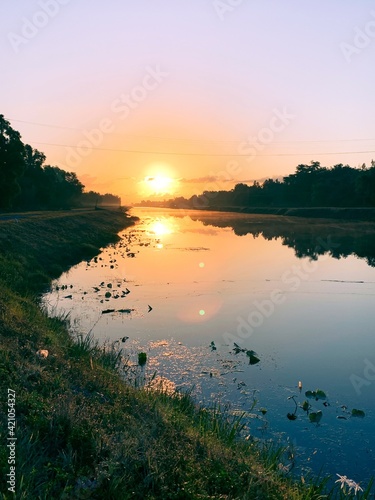 Fototapeta Naklejka Na Ścianę i Meble -  Sunrise over a drainage canal in Weston Florida.
