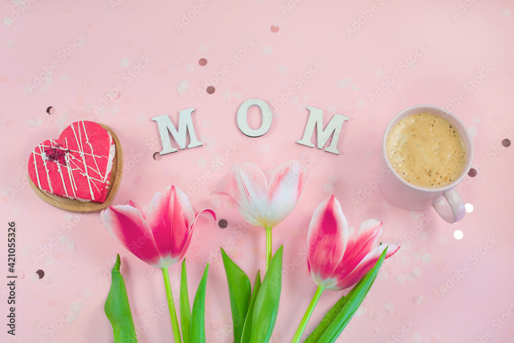 Wooden letters in the phrase MOM with flowers, cookie and coffee