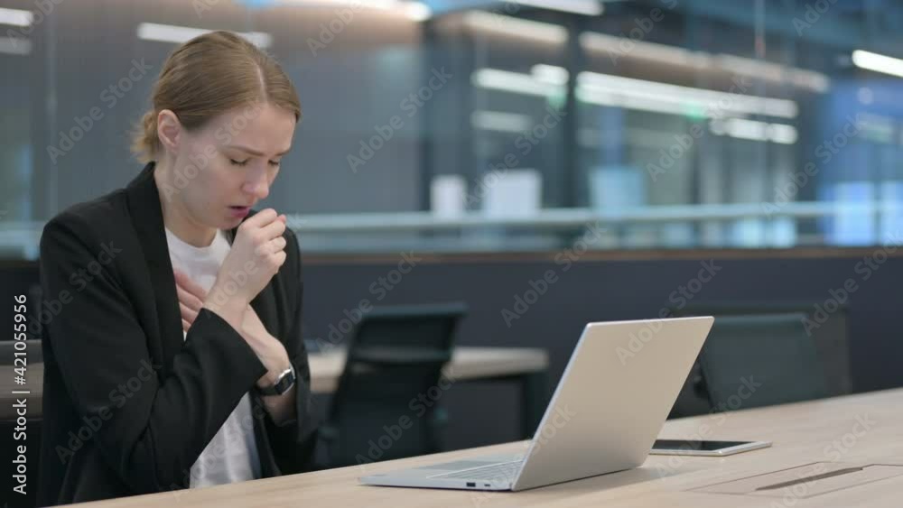 Businesswoman Coughing while using Laptop at Work 