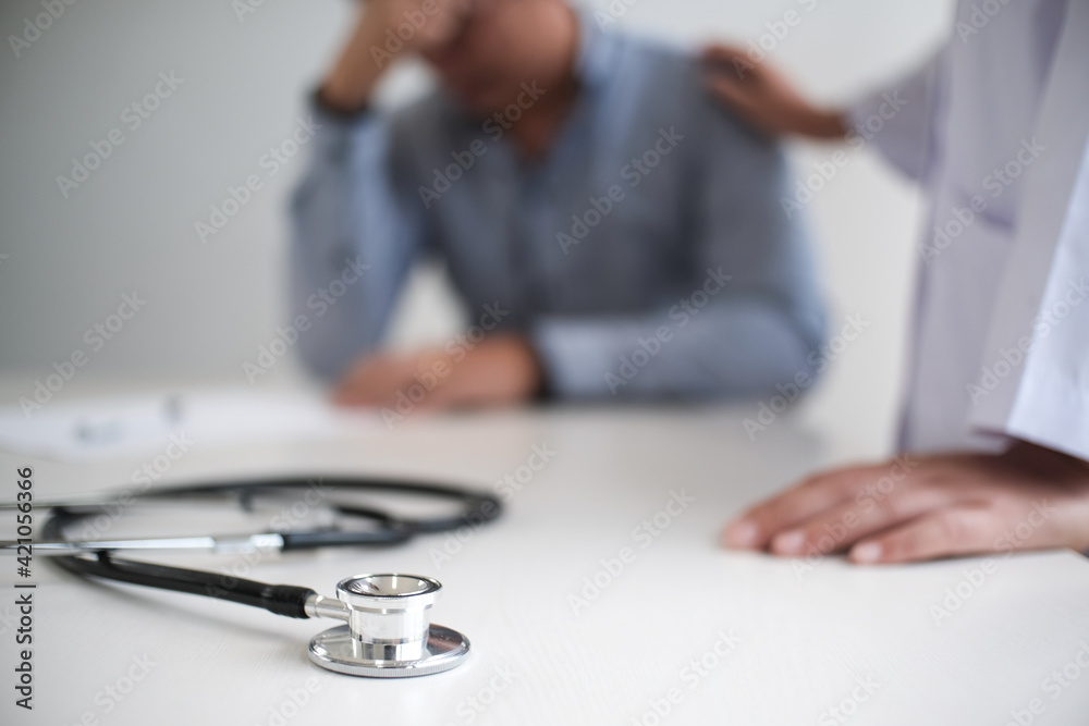 Doctor healthcare. Professional medical doctor in white uniform gown coat interview consulting patient reassuring his male patient helping hand Doctor healthcare. Professional medical doctor in white uniform gown coat interview consulting patient reassuring his male patient helping hand