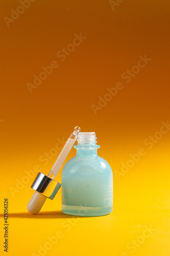 Serum with hyaluronic acid Mizon on a yellow background