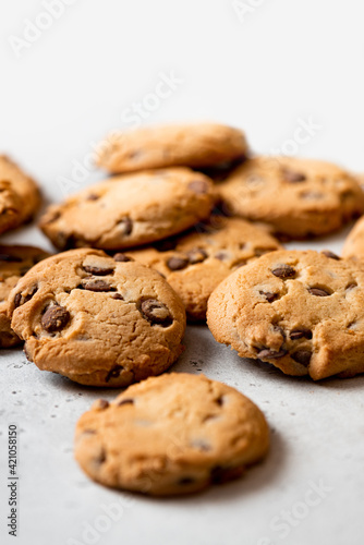 Chocolate cookies on a gray concrete background top view. Free space for text. Cookies background.