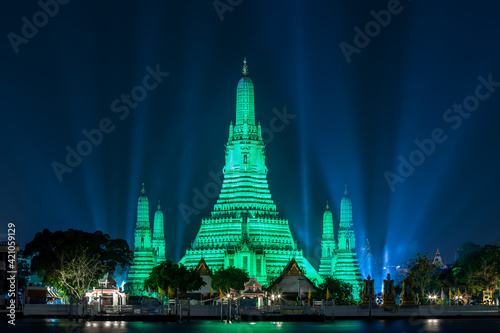 Wat arun ratchawararam lights up green to celebrate St. Patrick's Day.