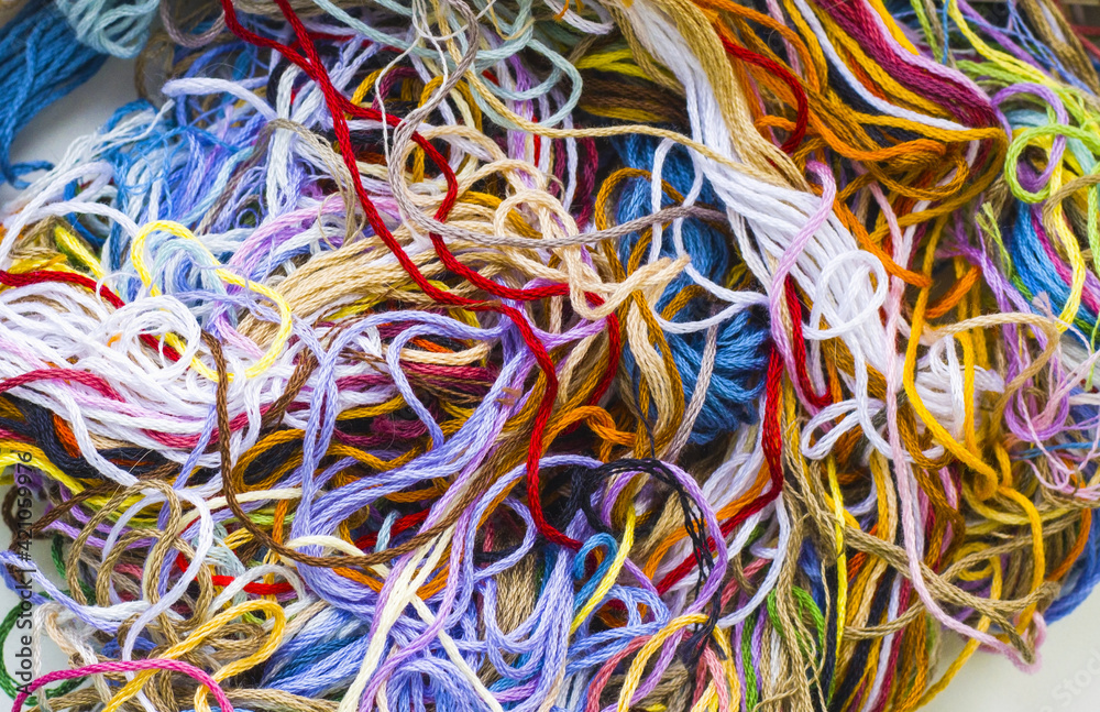 multi-colored mixed-up embroidery threads, a bunch of threads