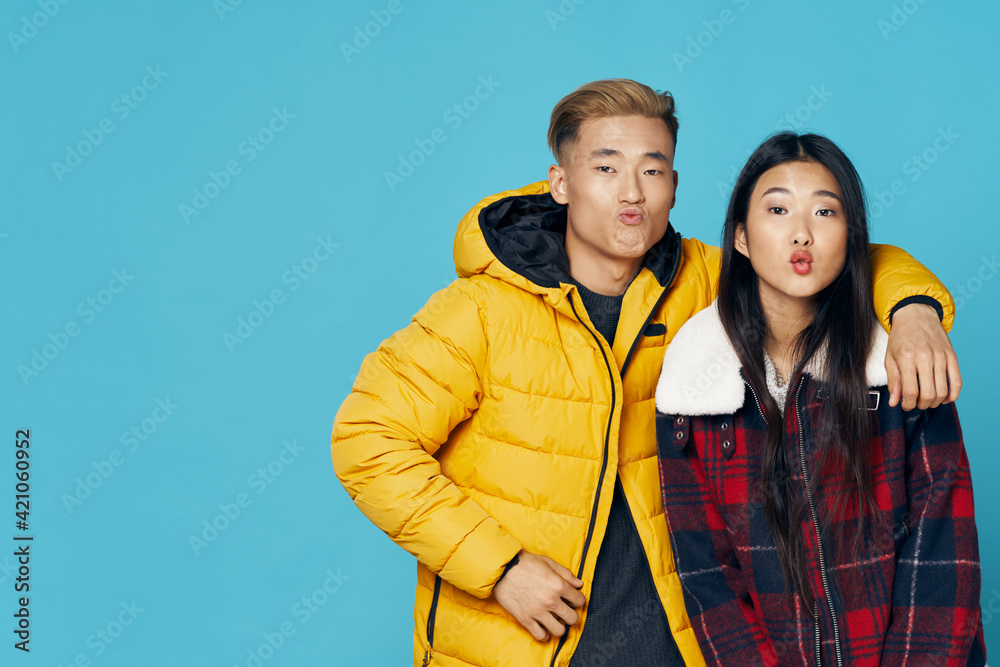 Man in a yellow jacket Asian appearance and woman air kiss Man in a yellow jacket Asian appearance and woman air kiss
