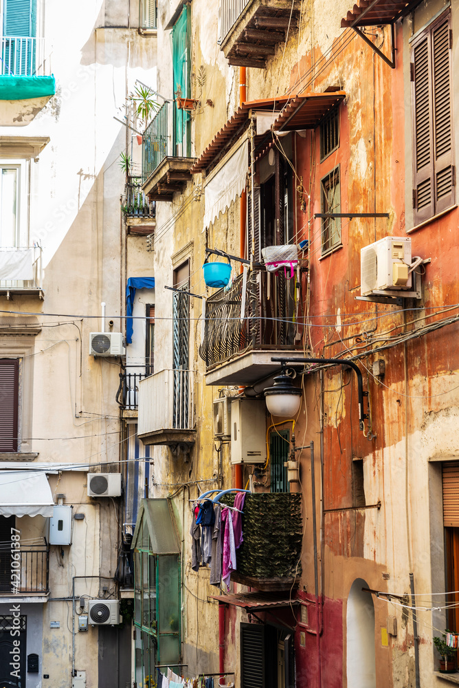 Facade of classic buildings with hanging clothes in Naples, Italy