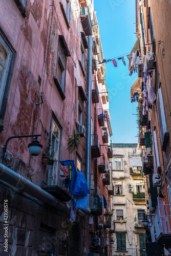 Facade of classic buildings with hanging clothes in Naples, Italy © jordi2r