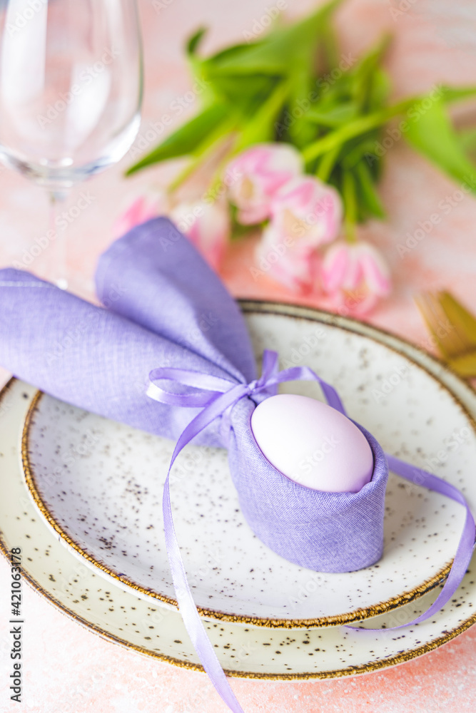 Easter table setting with pink tulip flowers and easter egg Easter table setting with pink tulip flowers and easter egg