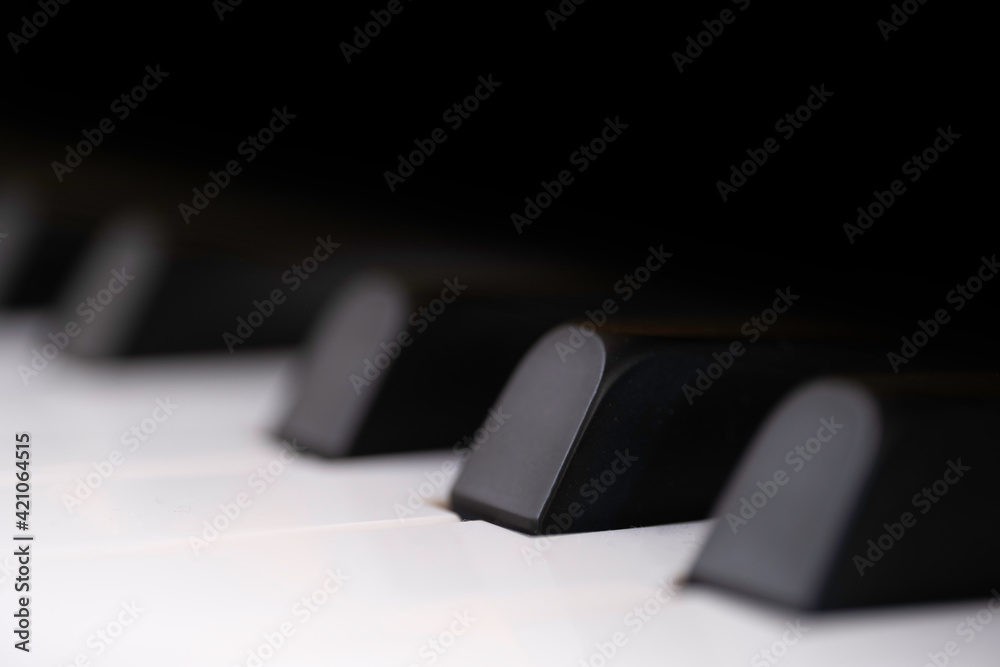 Black and white piano keys side view with shallow depth of field. The black keys are called sharps or flats.
Focus on the second black key from the left. Copy space