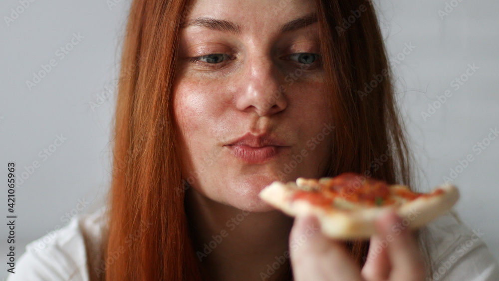 Young woman with long hair holding tasty big slice of pizza ready to eat at home Young woman with long hair holding tasty big slice of pizza ready to eat at home