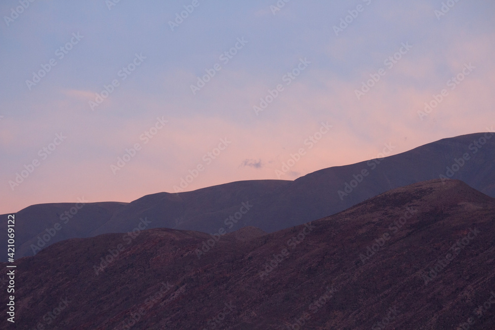 Enchanting landscape background. View of the mountains at sunset with a beautiful dusk light and colors.  