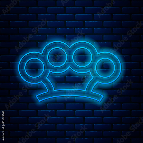 Glowing neon line Brass knuckles icon isolated on brick wall background. Vector