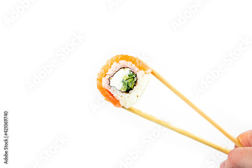 take philadelphia maki rolls with bamboo chopstick on white background